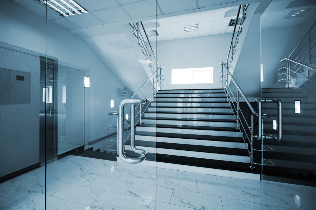 a glass security door entrance leading to a staircase