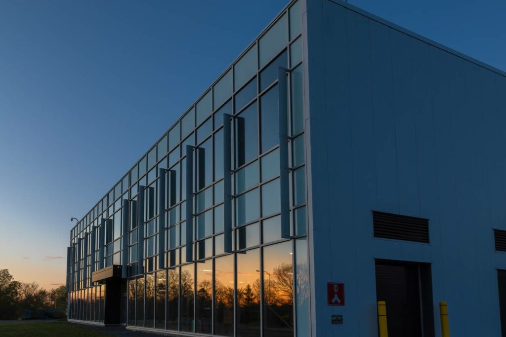 Evening sky reflecting off the window panels of a large building