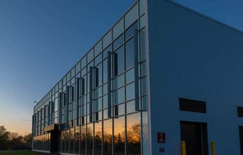 Evening sky reflecting off the window panels of a large building