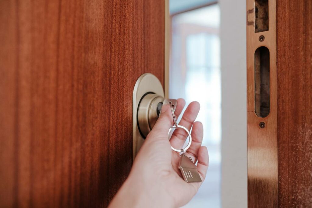 Person locking a door with a key