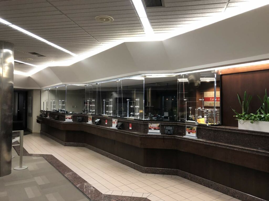 lined bulletproof glass barriers in a bank