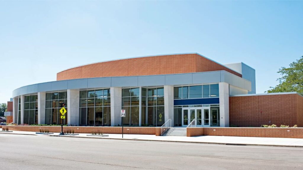 The front of a large building with many glass windows