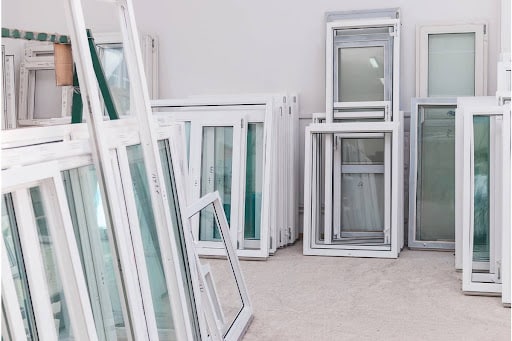 ballistic glass panels with white frames stored in a room